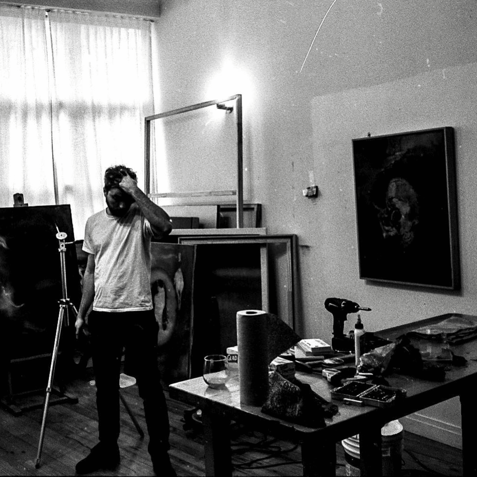 Black and white photograph of Julian at work in the studio.