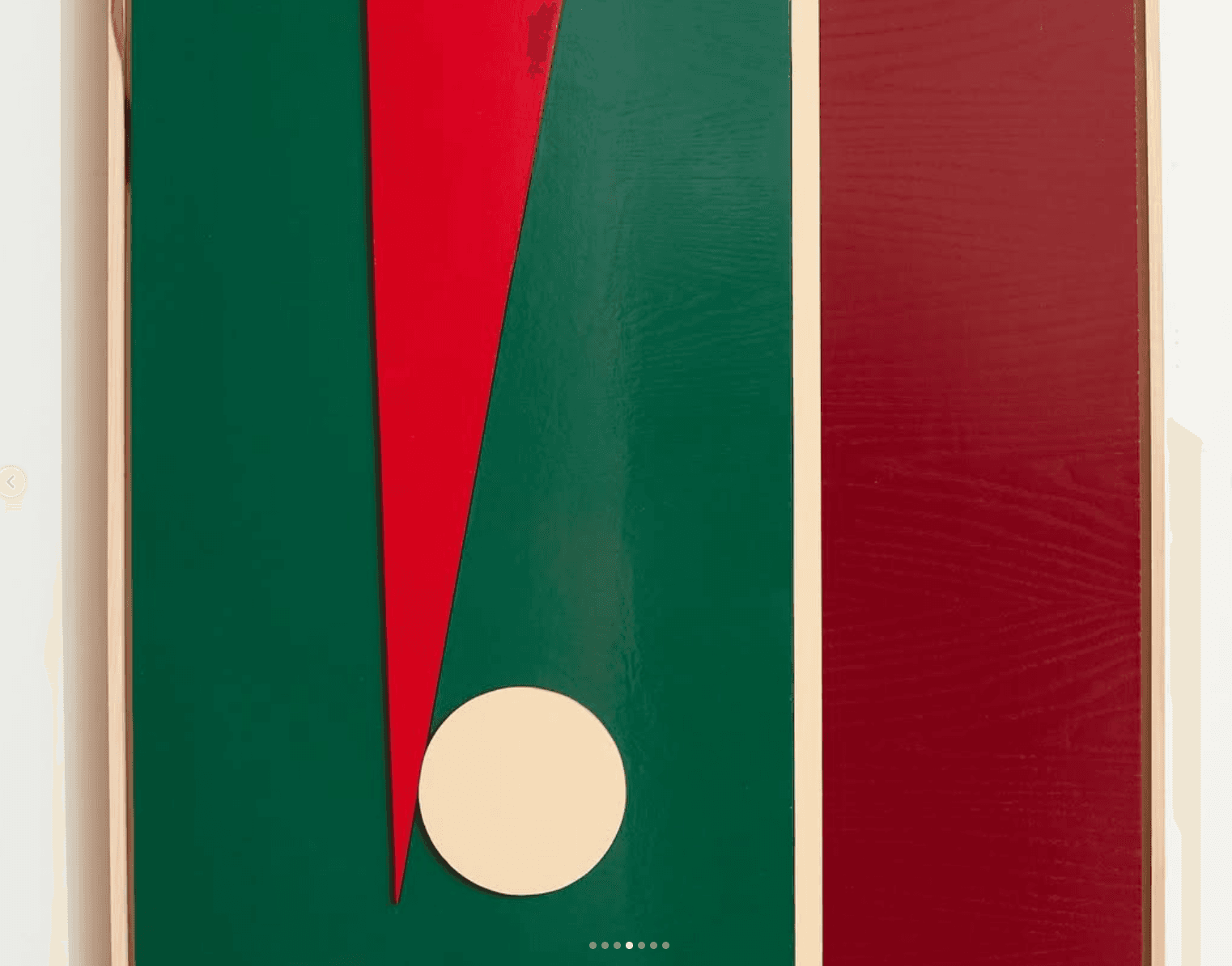 Green relief panel with a red triangle, cream circle and maroon stripe.
