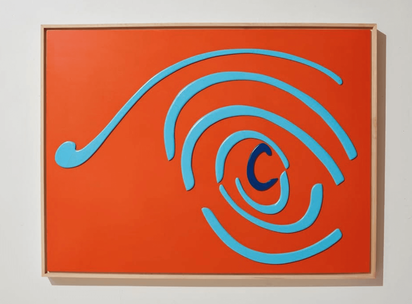 Orange panel with a light-blue spiral curling into a dark navy center.